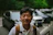 a man standing in front of a parking lot