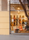 a store front with a display of handbags in the window