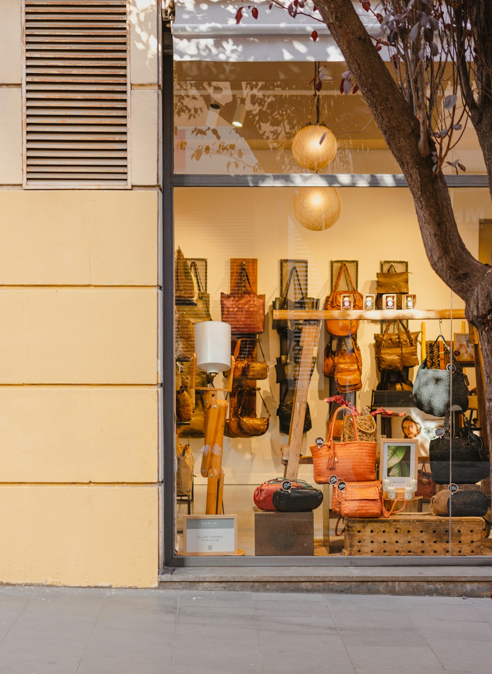 a store front with a display of handbags in the window