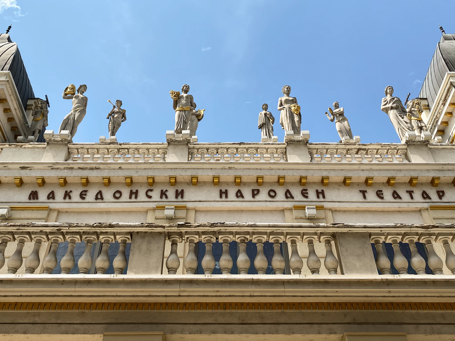 a large building with statues on top of it