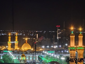 An elegant night view of Riyadh's skyline with golden lights illuminating the city.