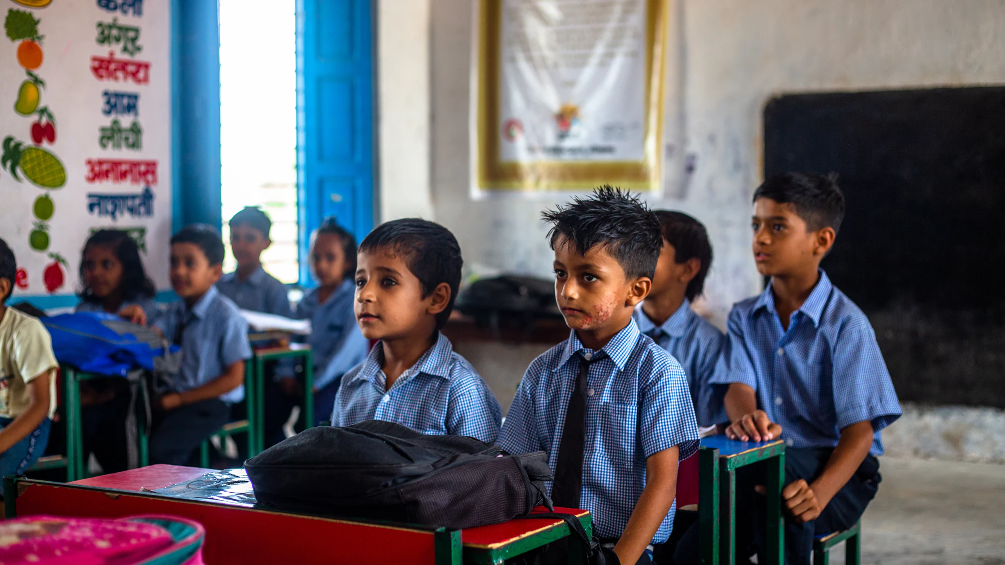 A group of young children sitting together in a classroom
