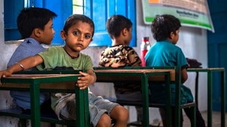a group of young children sitting at a table