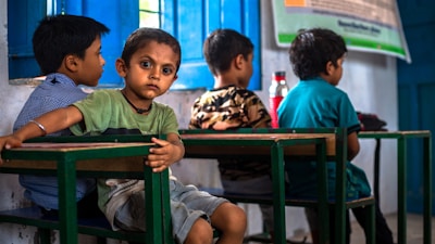 a group of young children sitting at a table