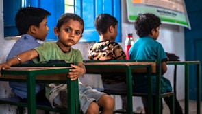 a group of young children sitting at a table