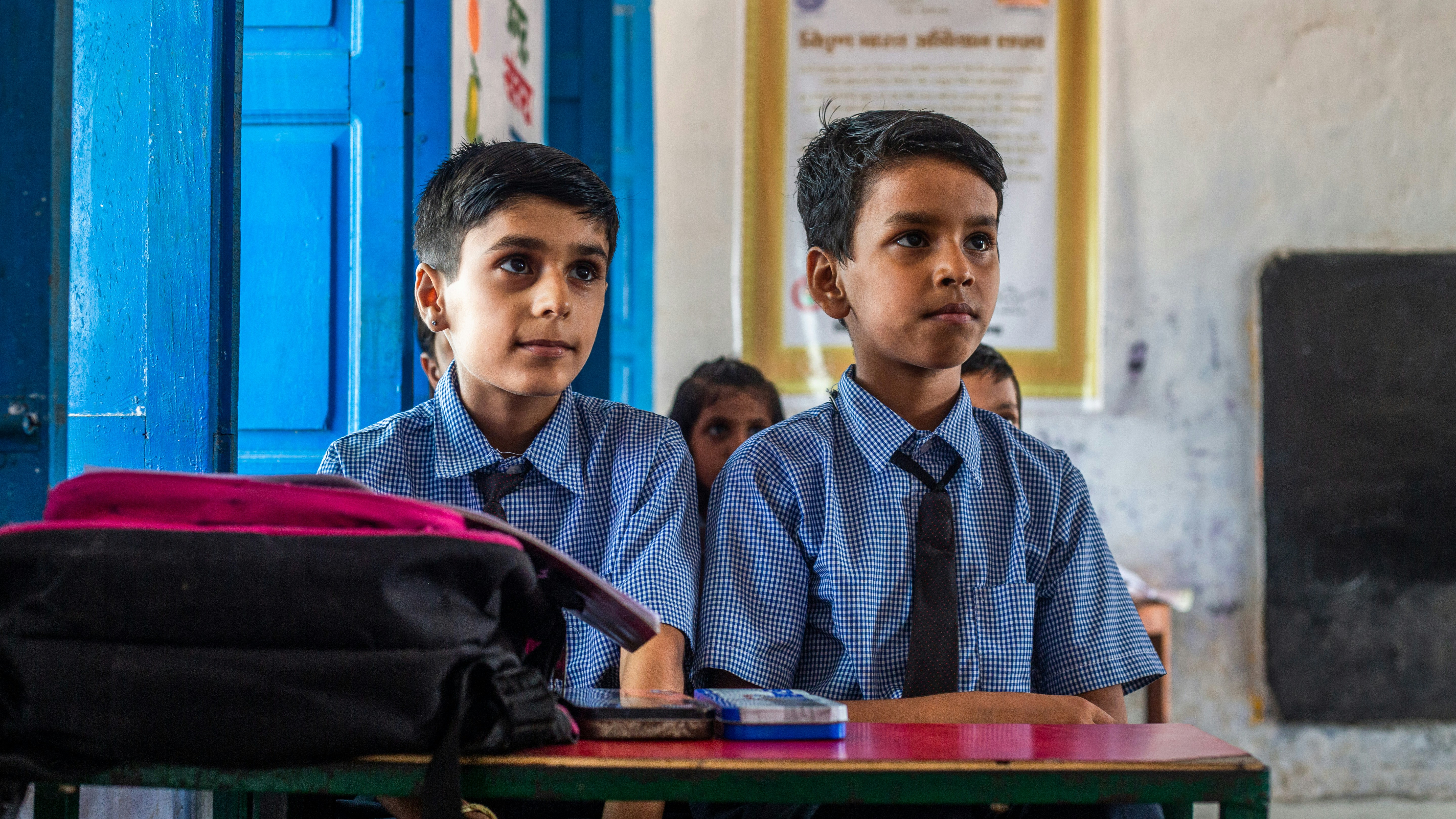 children in a classroom focused on education
