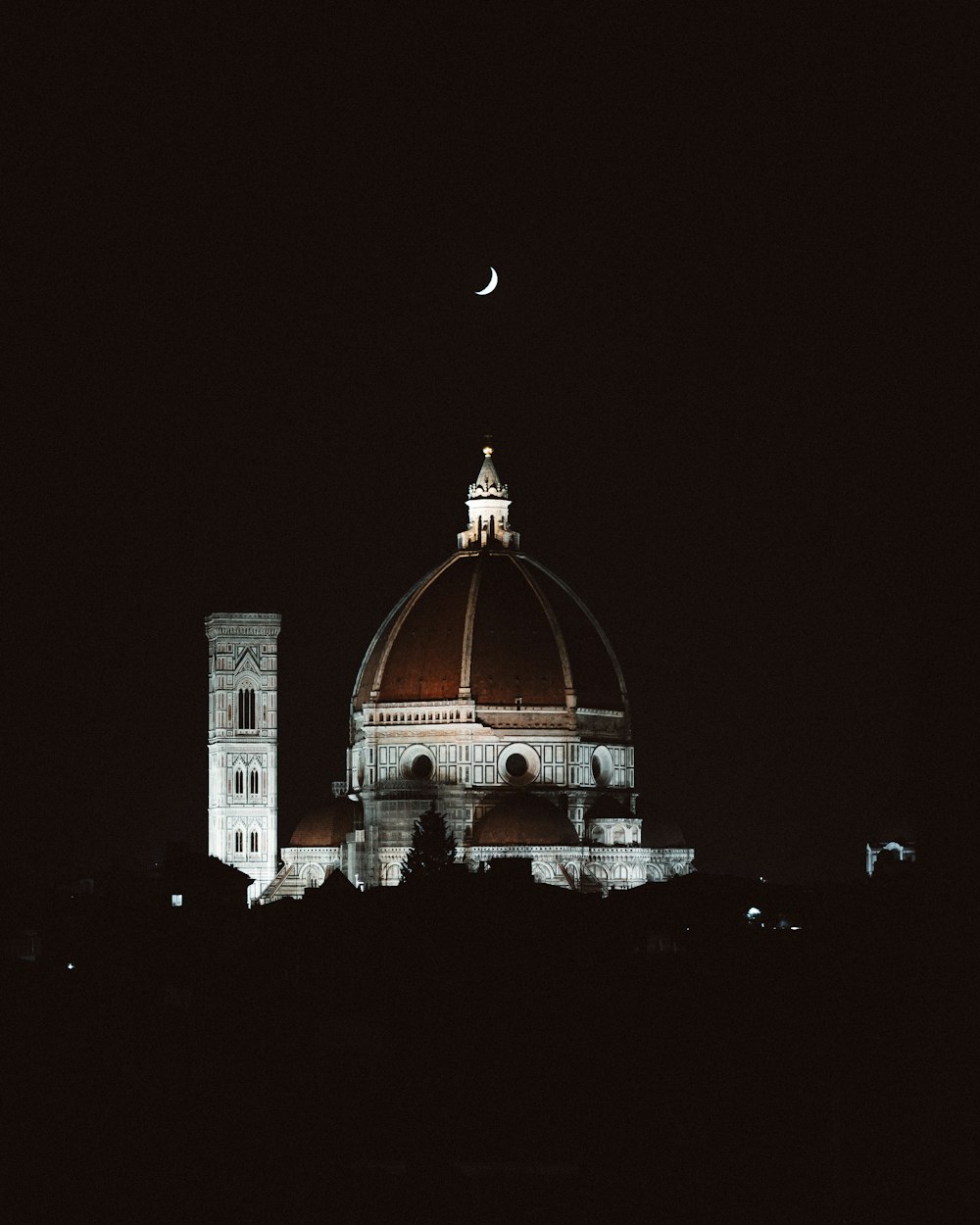 a large building with a clock tower at night