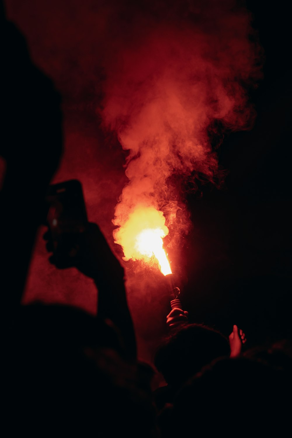 a person taking a picture of a fire