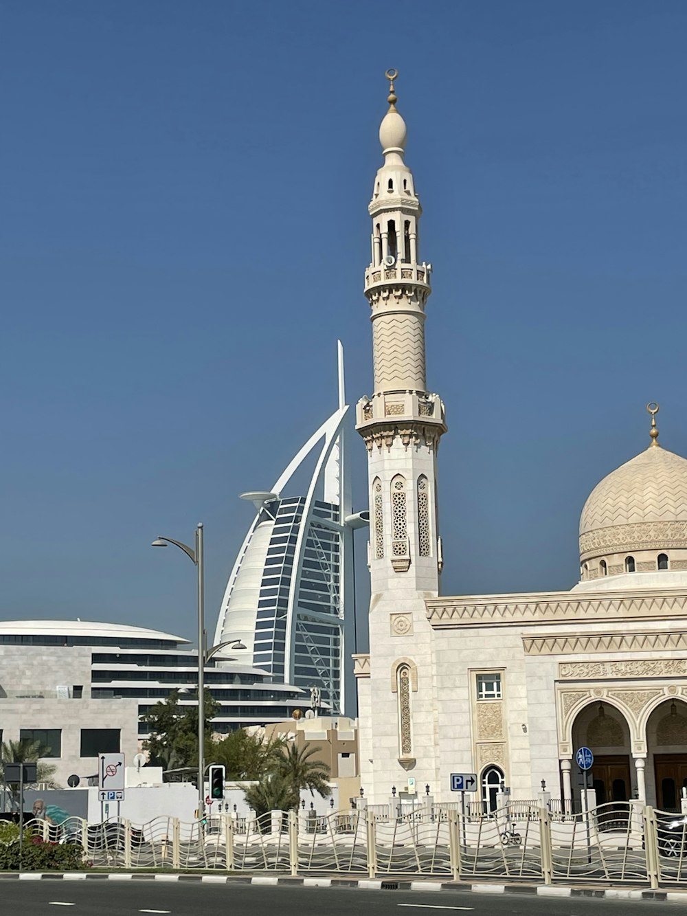 a tall white building with a clock tower