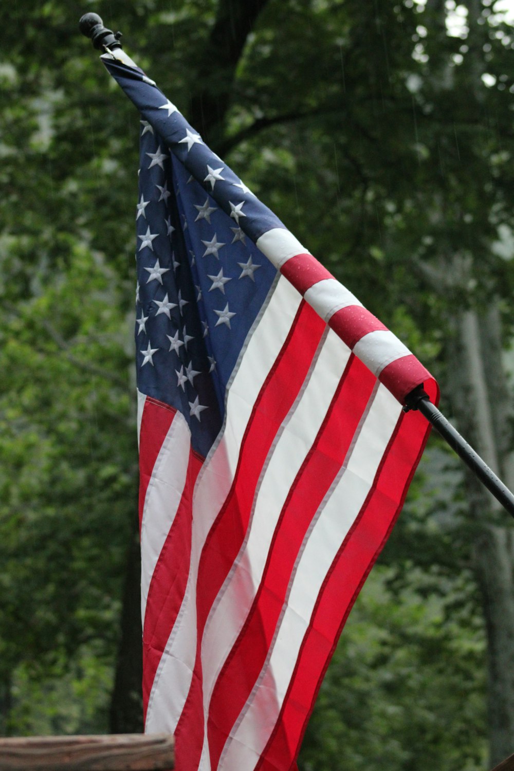 an american flag is flying in the wind