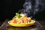 a yellow bowl filled with food on top of a wooden table