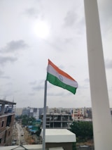 Dr. Rajesh Rankhambe speaking at a political conference with the Indian flag in the background.