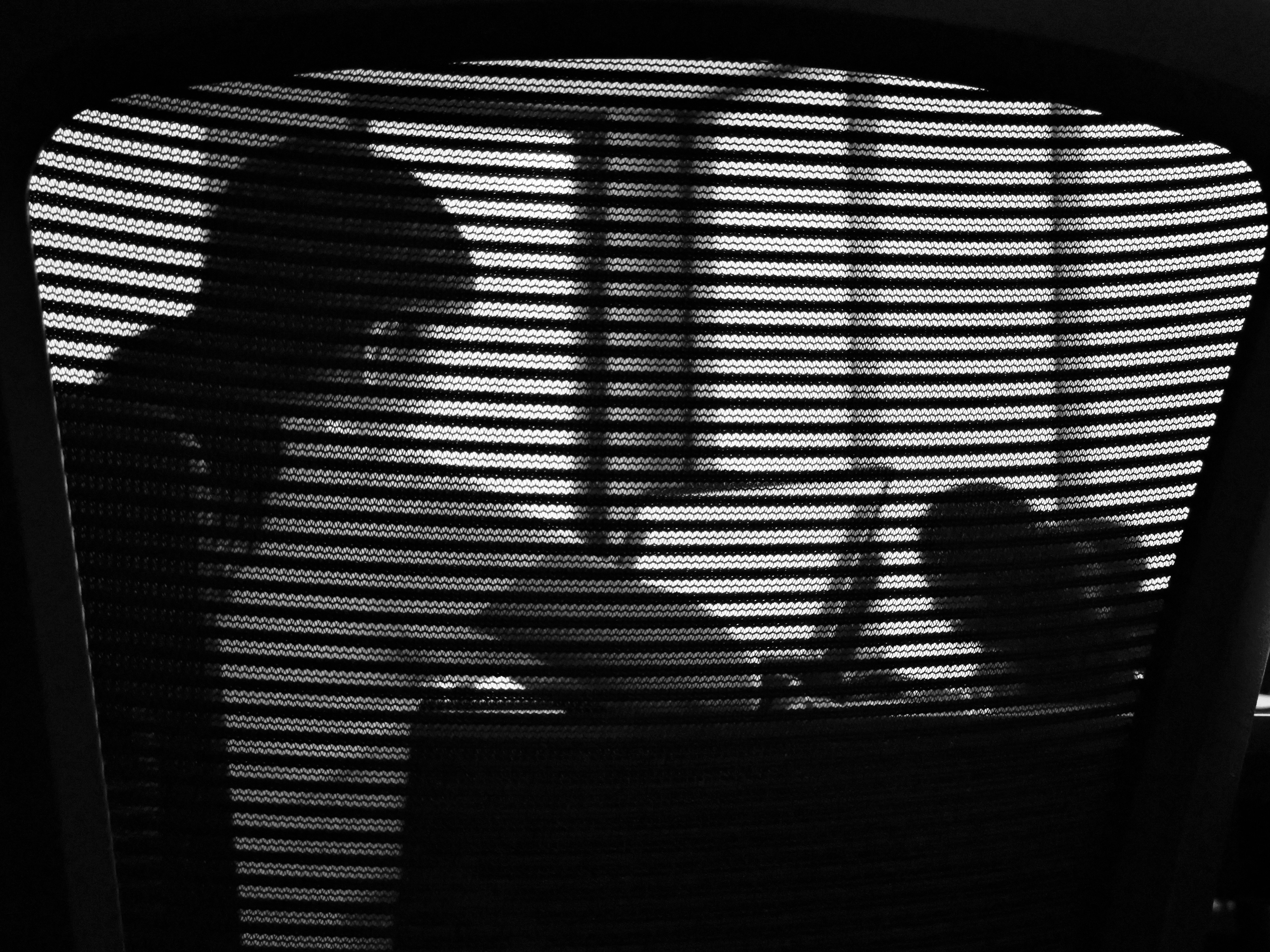 a person sitting in a chair in front of a window