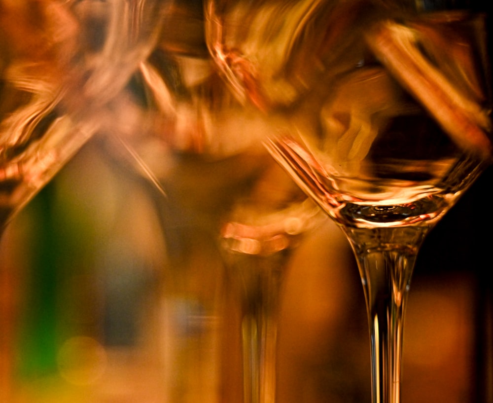 a close up of a wine glass with a blurry background