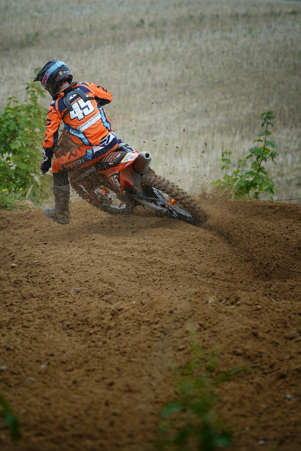 a man riding a dirt bike on top of a dirt field