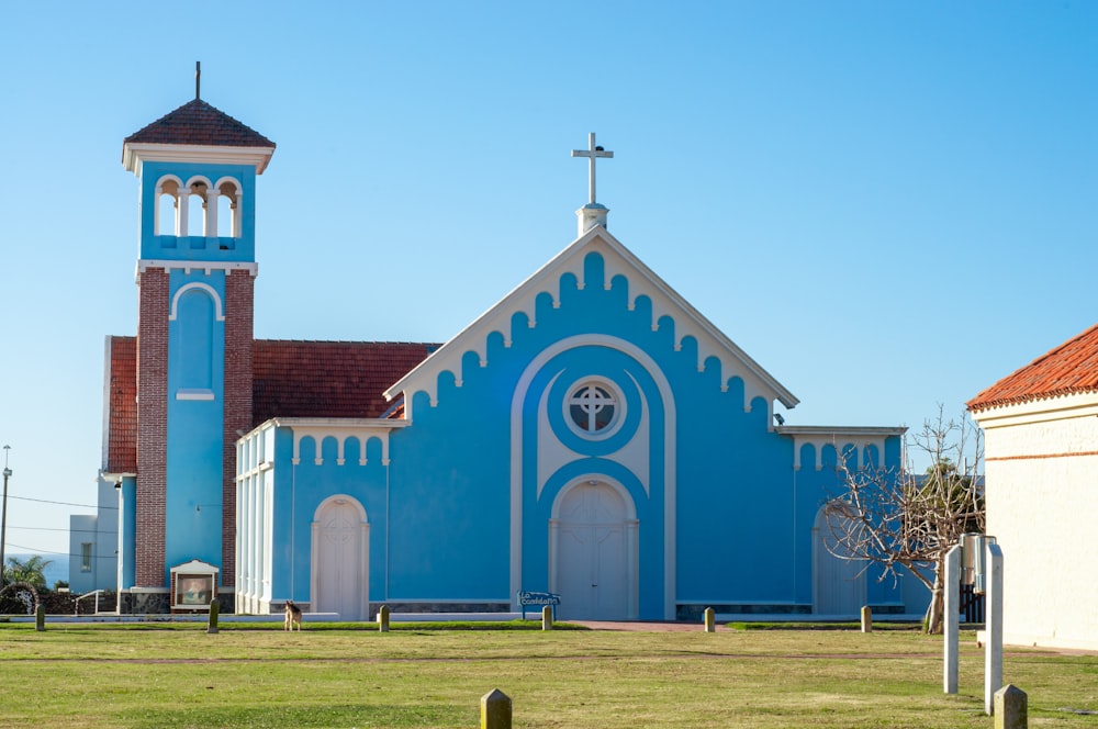 a blue and white church with a cross on top