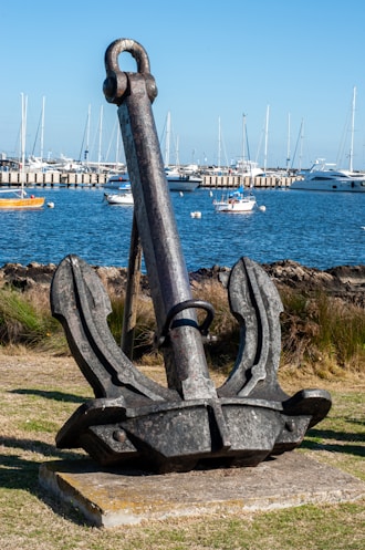a statue of an anchor in a harbor