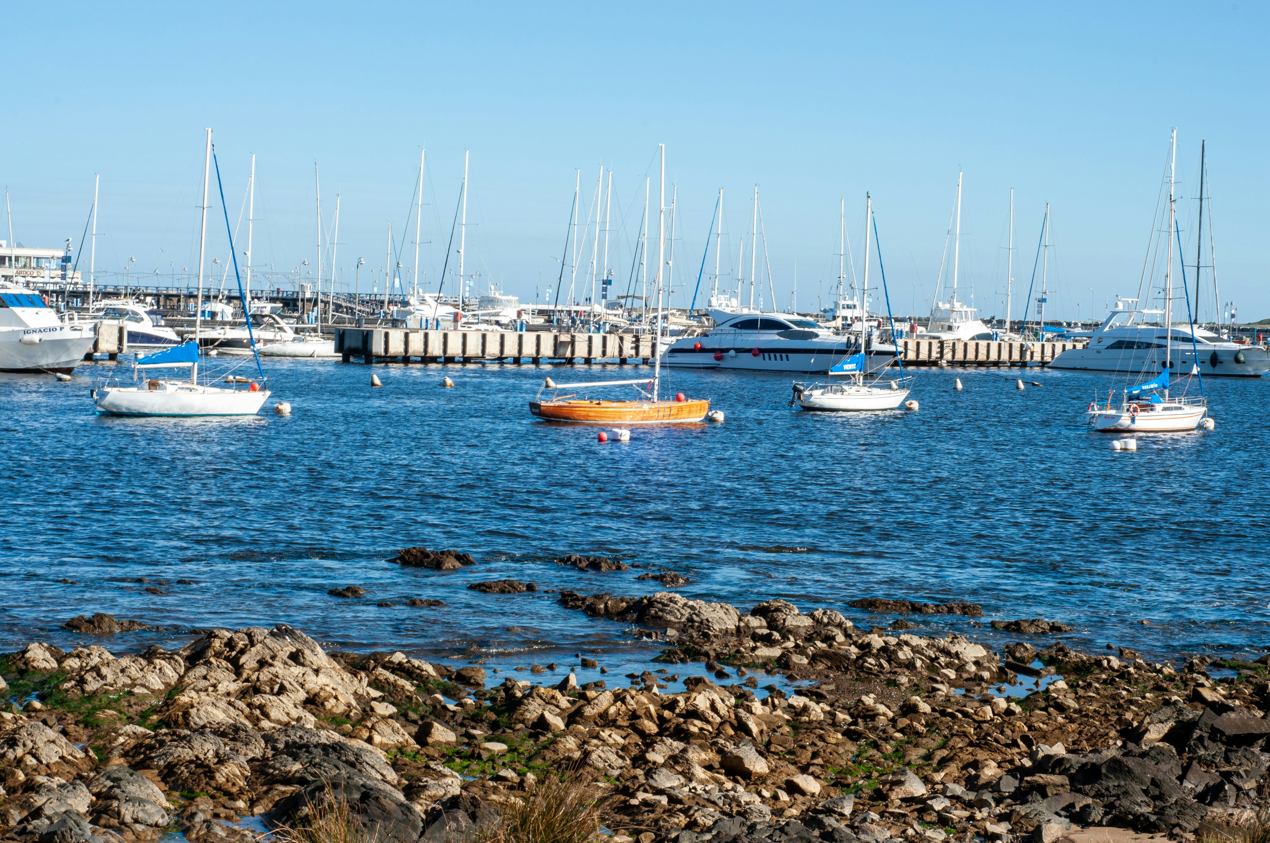 a group of boats floating on top of a body of water