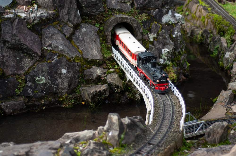 a toy train is coming out of a tunnel