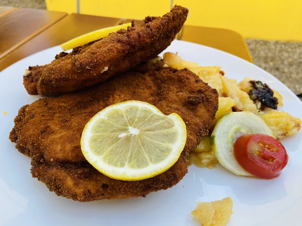 Close-up of a hearty Wiener Schnitzel served with lemon and parsley garnish.