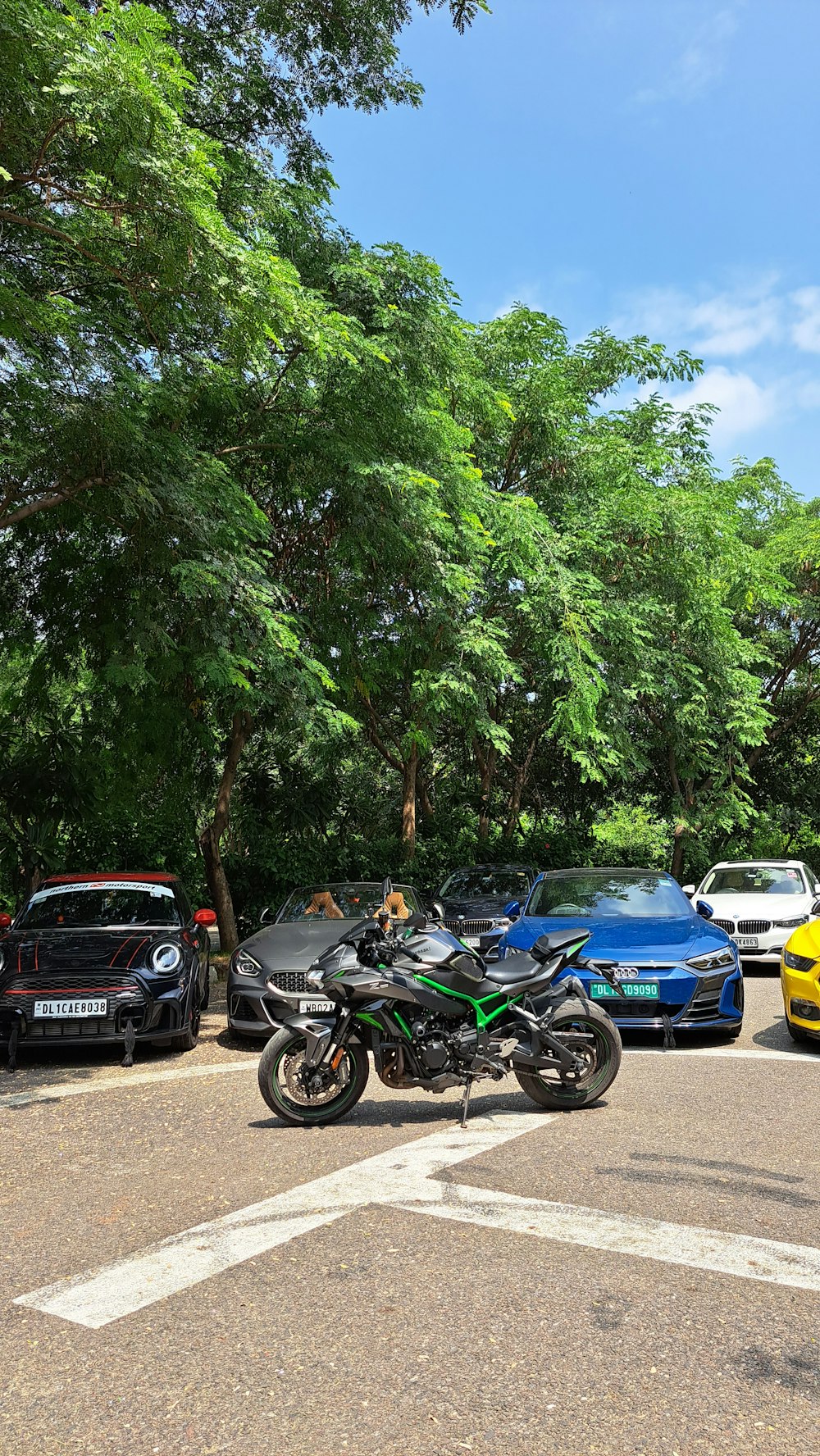 a motorcycle parked in a parking lot next to other cars