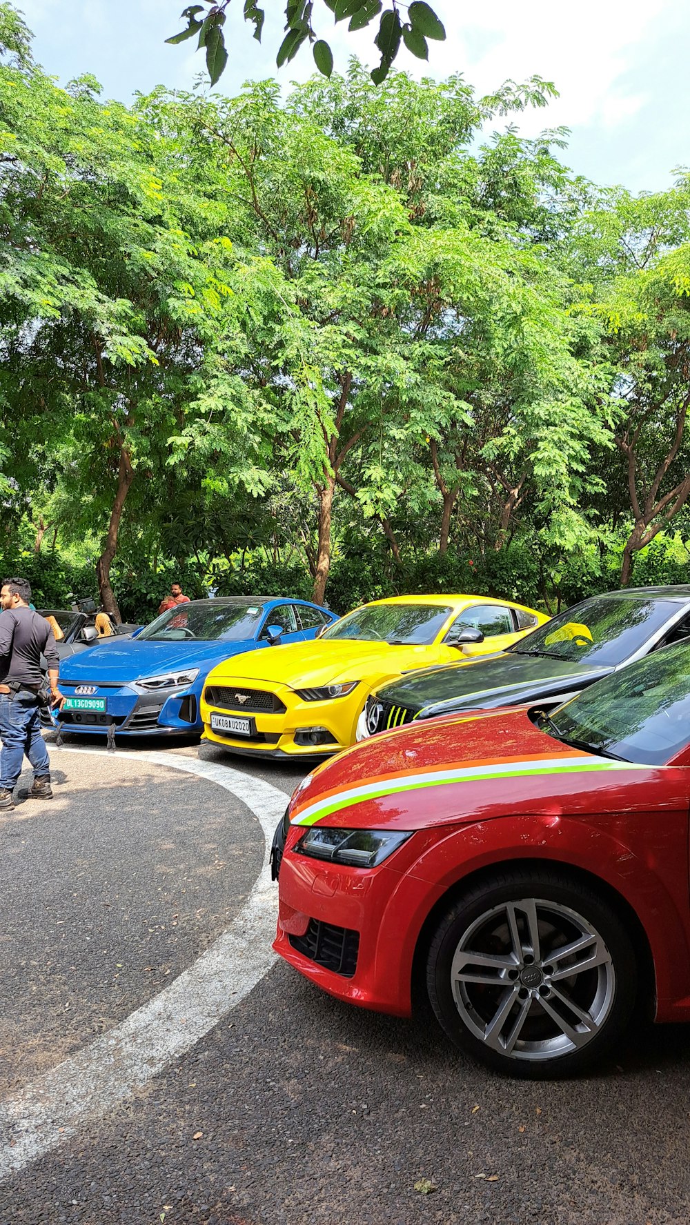 a group of cars parked next to each other in a parking lot