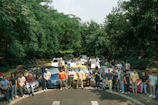 A vibrant photo of a group of Korembi members standing proudly beside their rental cars on a sunny day.
