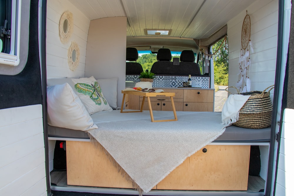 the inside of a camper with a bed and a table
