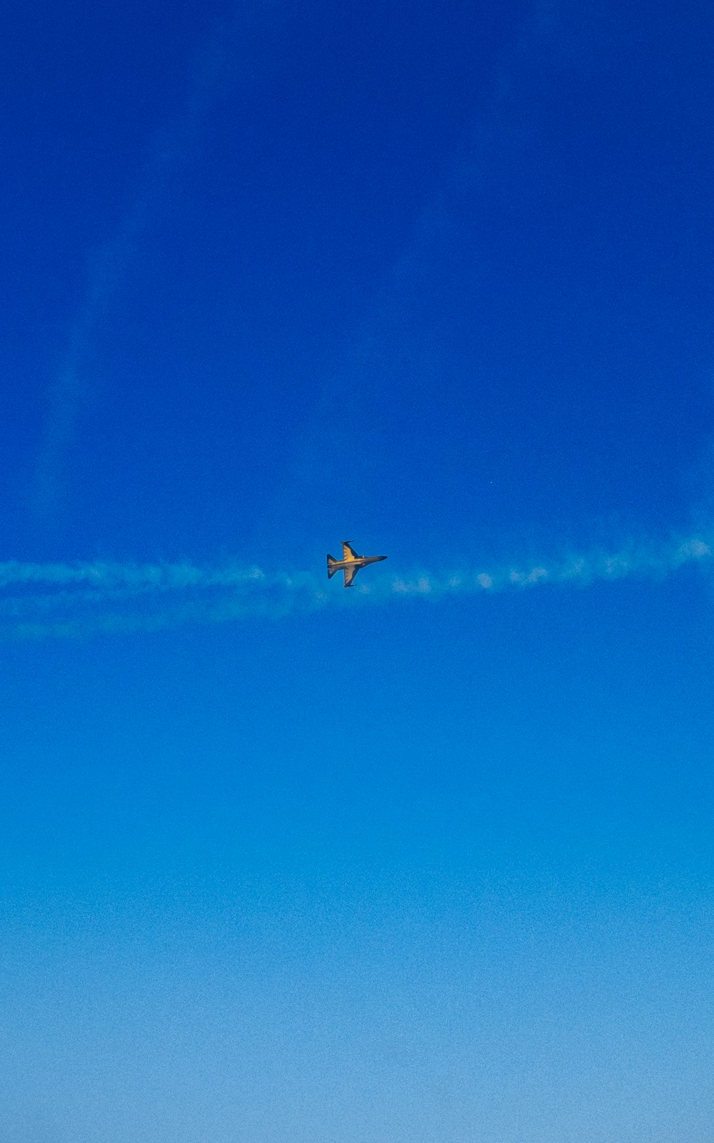 an airplane is flying in the blue sky