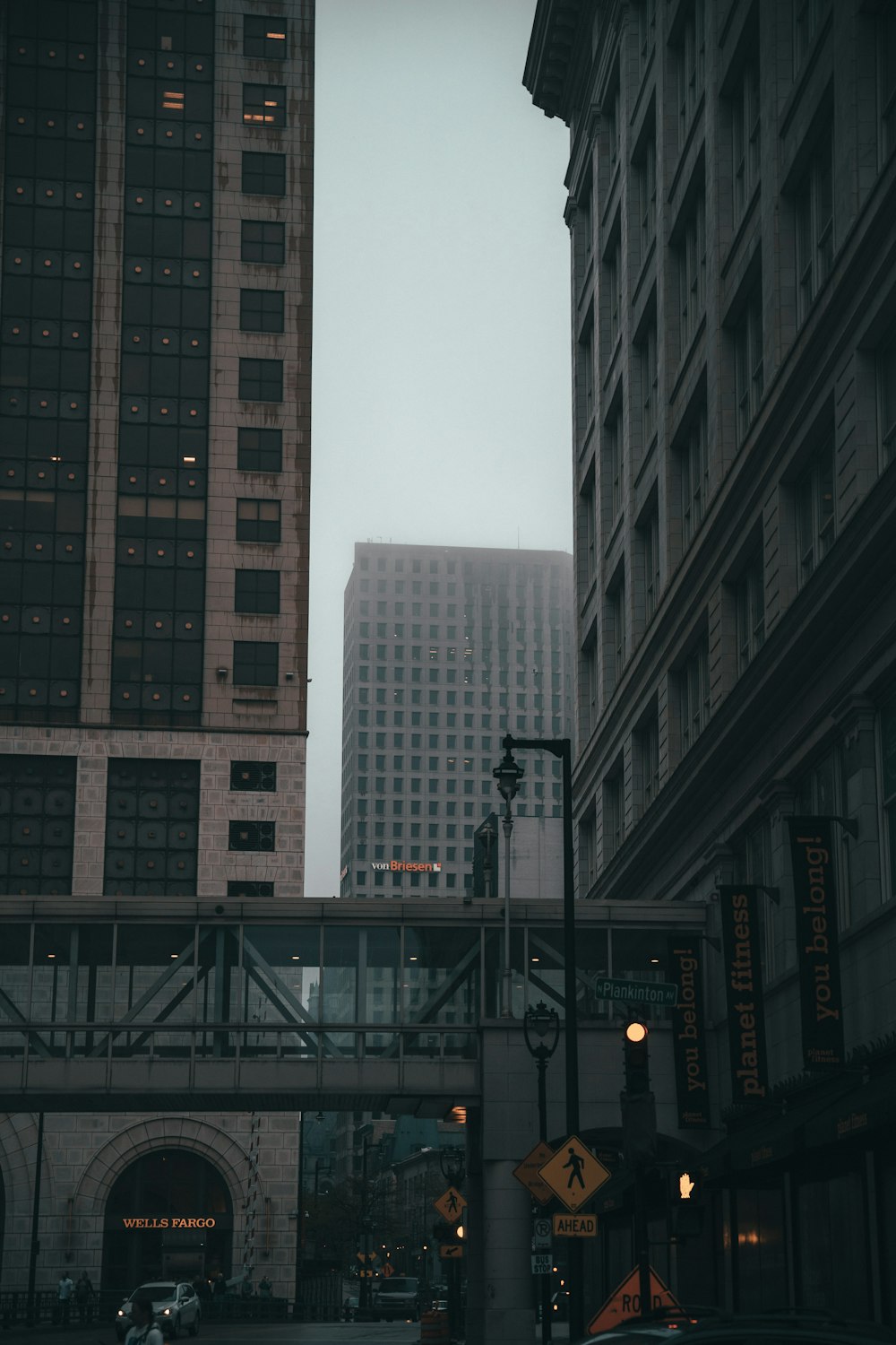 a city street with tall buildings in the background