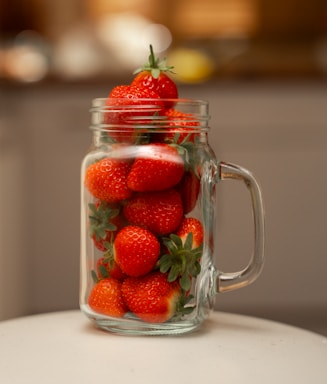 Close-up of a jar of traditional Spanish strawberry jam with fresh strawberries around it
