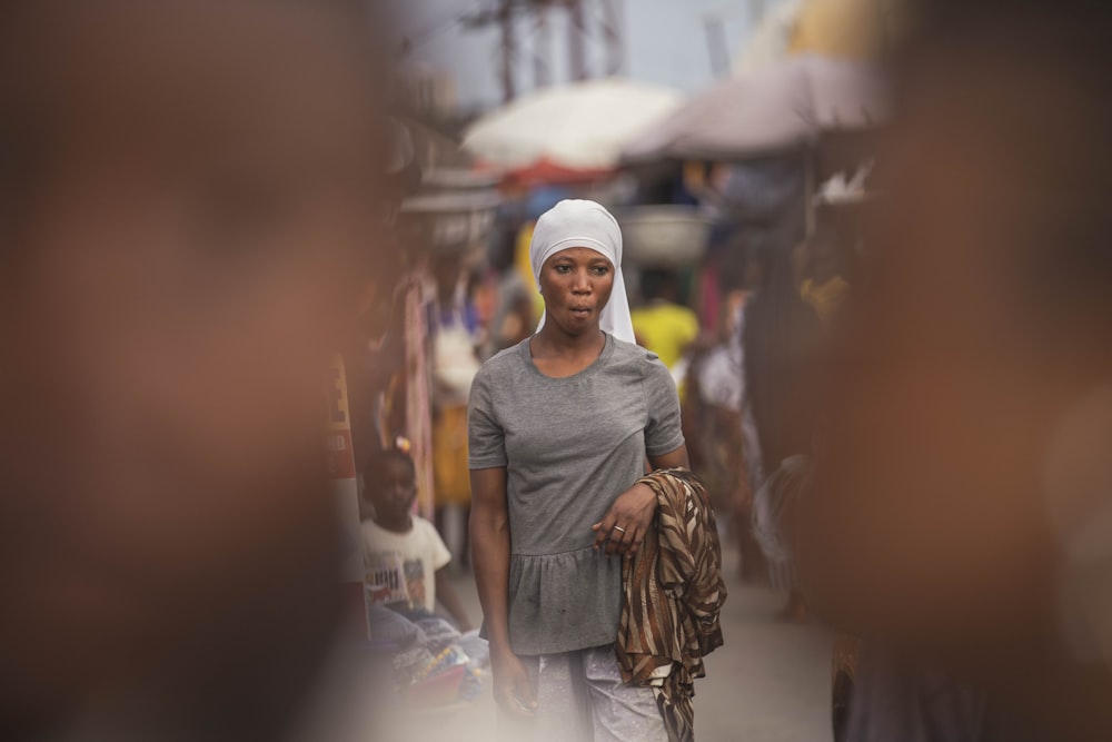 a woman walking down a street with an umbrella