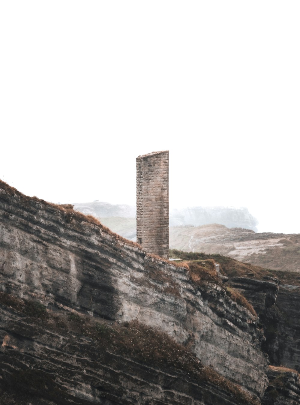 a tall tower sitting on the side of a cliff