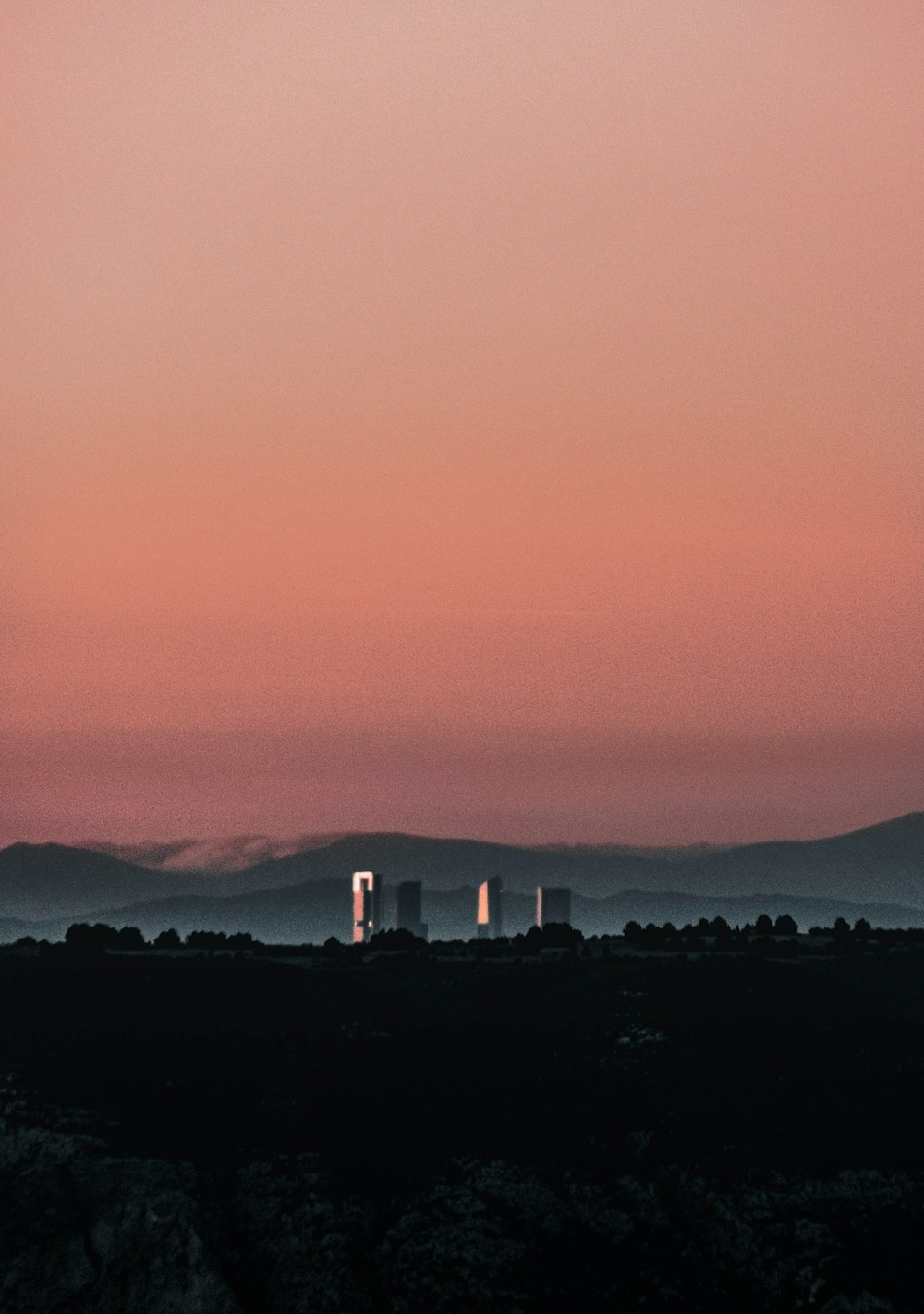 a view of a city with mountains in the background