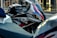 A close-up of a high-quality motorcycle parked in a modern urban environment.