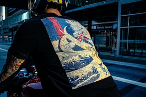 Close-up of a black oversized t-shirt featuring a striking anime-inspired dragon print on the back