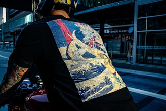 Close-up of a black oversized t-shirt featuring a striking anime-inspired dragon print on the back