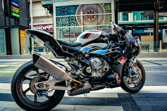 A sleek motorcycle equipped with a GPS tracking device on a city street.