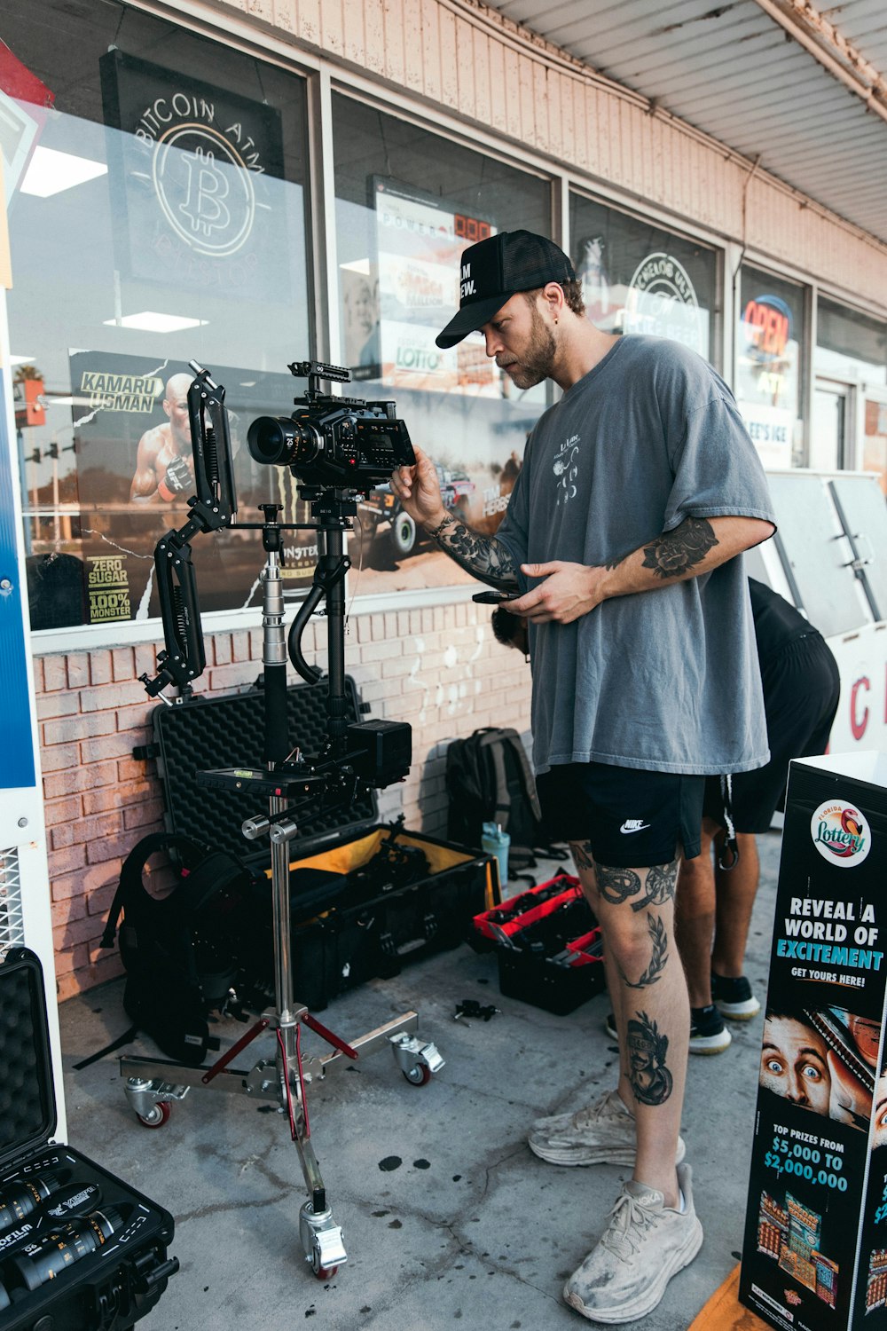 a man standing in front of a camera on a tripod