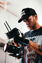 a man holding a camera and recording a video