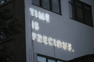 a neon sign that reads time is precious