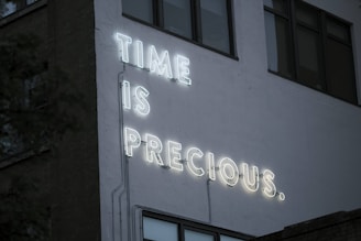 a neon sign that reads time is precious