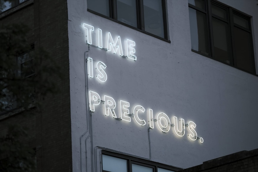 a neon sign that reads time is precious