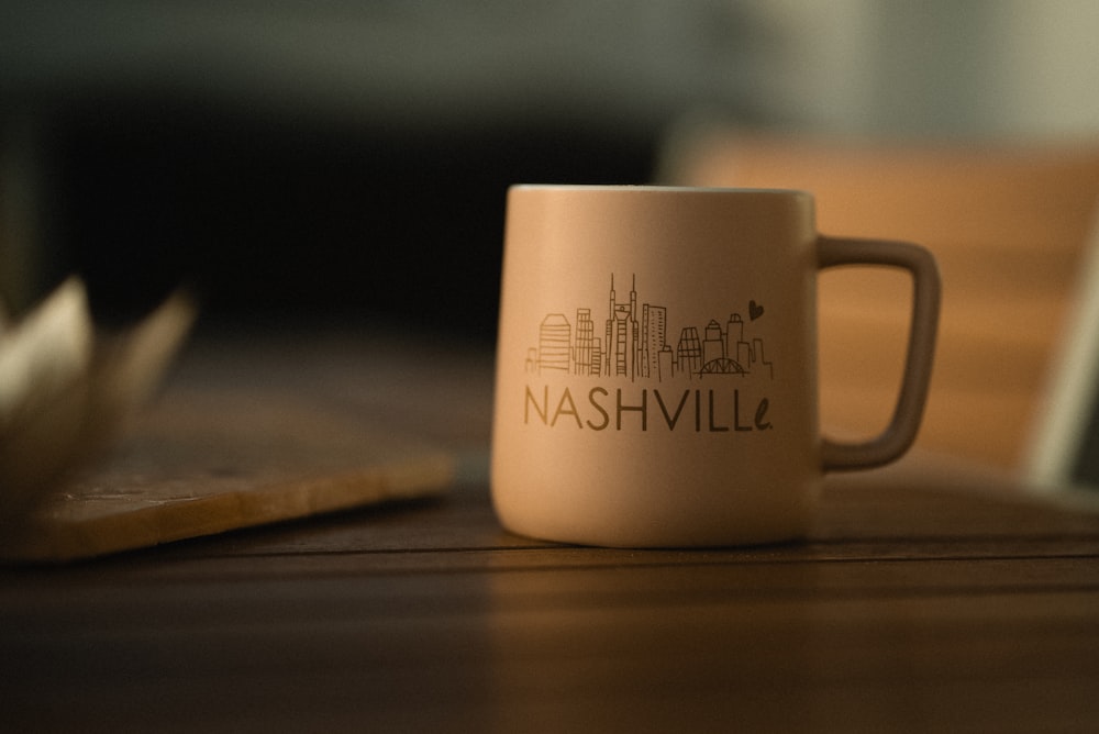 a coffee cup sitting on top of a wooden table