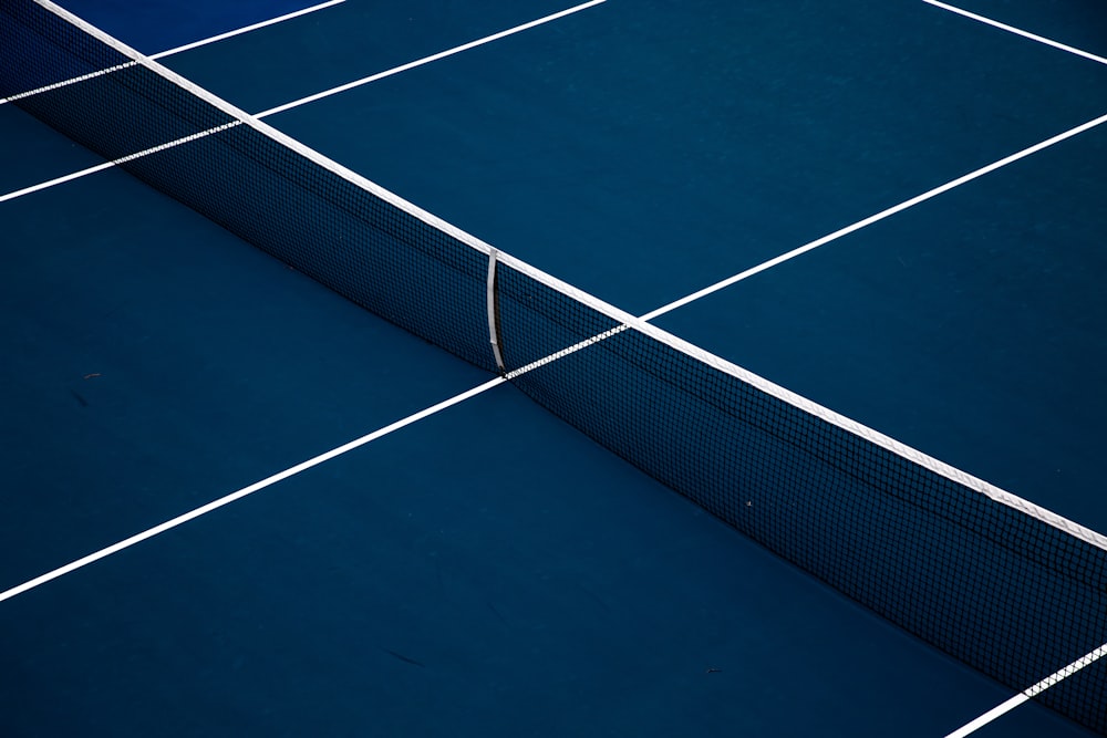 a blue tennis court with a white line on it