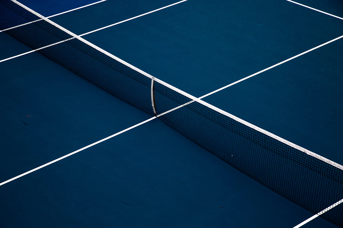 Blue tennis court surface with white boundary line
