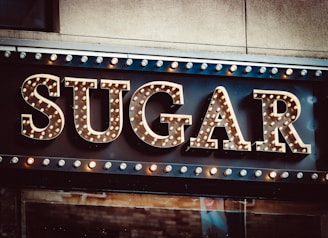 a sign that says sugar on the side of a building