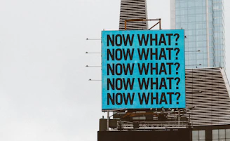 a large blue sign on top of a tall building