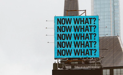 a large blue sign on top of a tall building