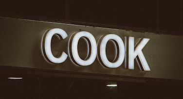 a close up of a sign that reads cook